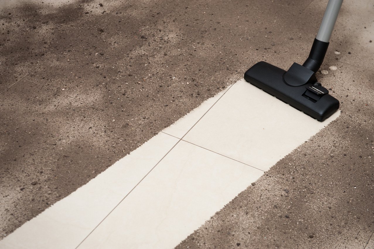 Vacuum cleaning dirt on a tiled floor